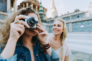 Couple of beautiful girls visiting bangkok maining attractions