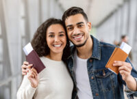 Happy Travellers. Portrait Of Young Arab Couple With Passports And Tickets Posing At Airport, Cheerful Smiling Middle Eastern Spouses Enjoying Travelling Together, Ready For Vacation Trip, Closeup