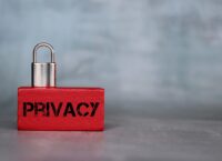 Padlock on wooden cube with text PRIVACY